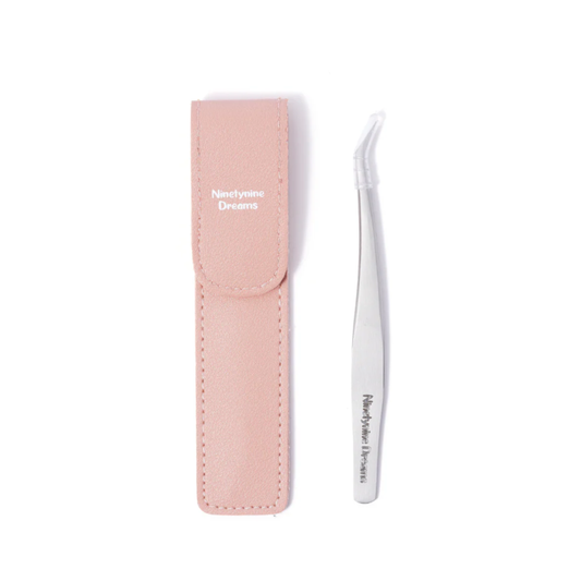 Product photo of Ninetynine Dreams pink eyelash tweezers showing casing and tweezer