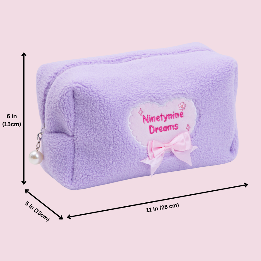 Purple plush pouch with 'Ninetynine Dreams' text and measurements on a light pink background
